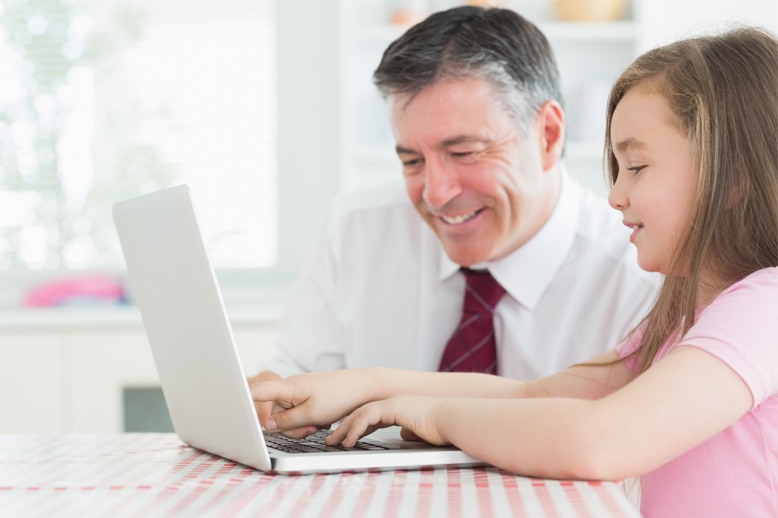 father daugther using laptop
