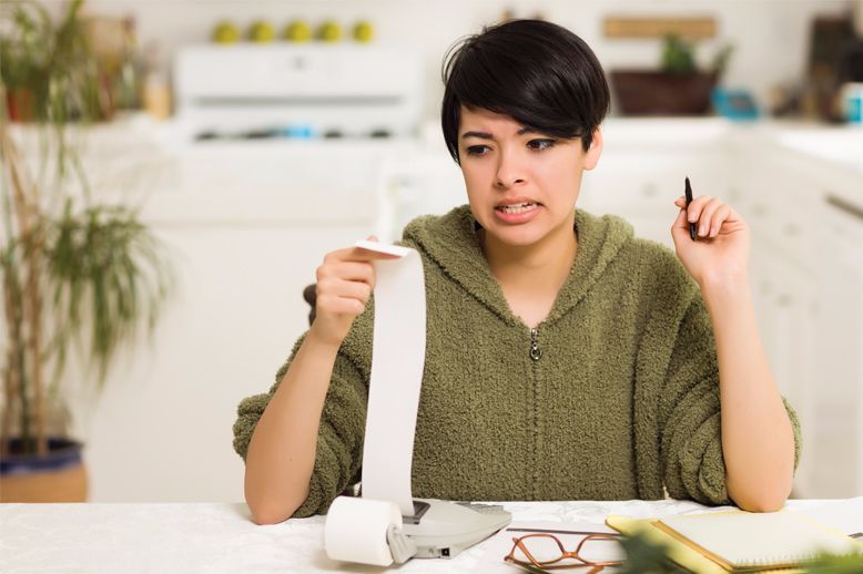 lady looking at calculator printout