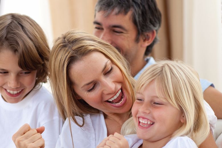 smiling mom dad and two kids