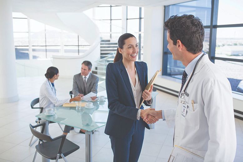 business woman and doctor shake hands