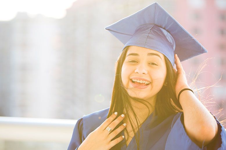 hispanic young girl graduate in cap and gown