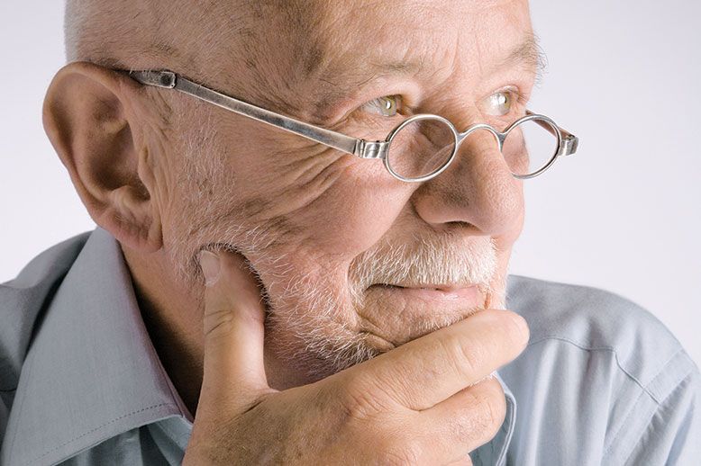 thoughtful older man with glasses