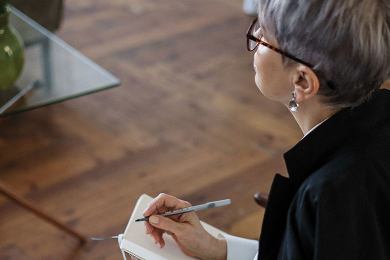 older woman with notebook