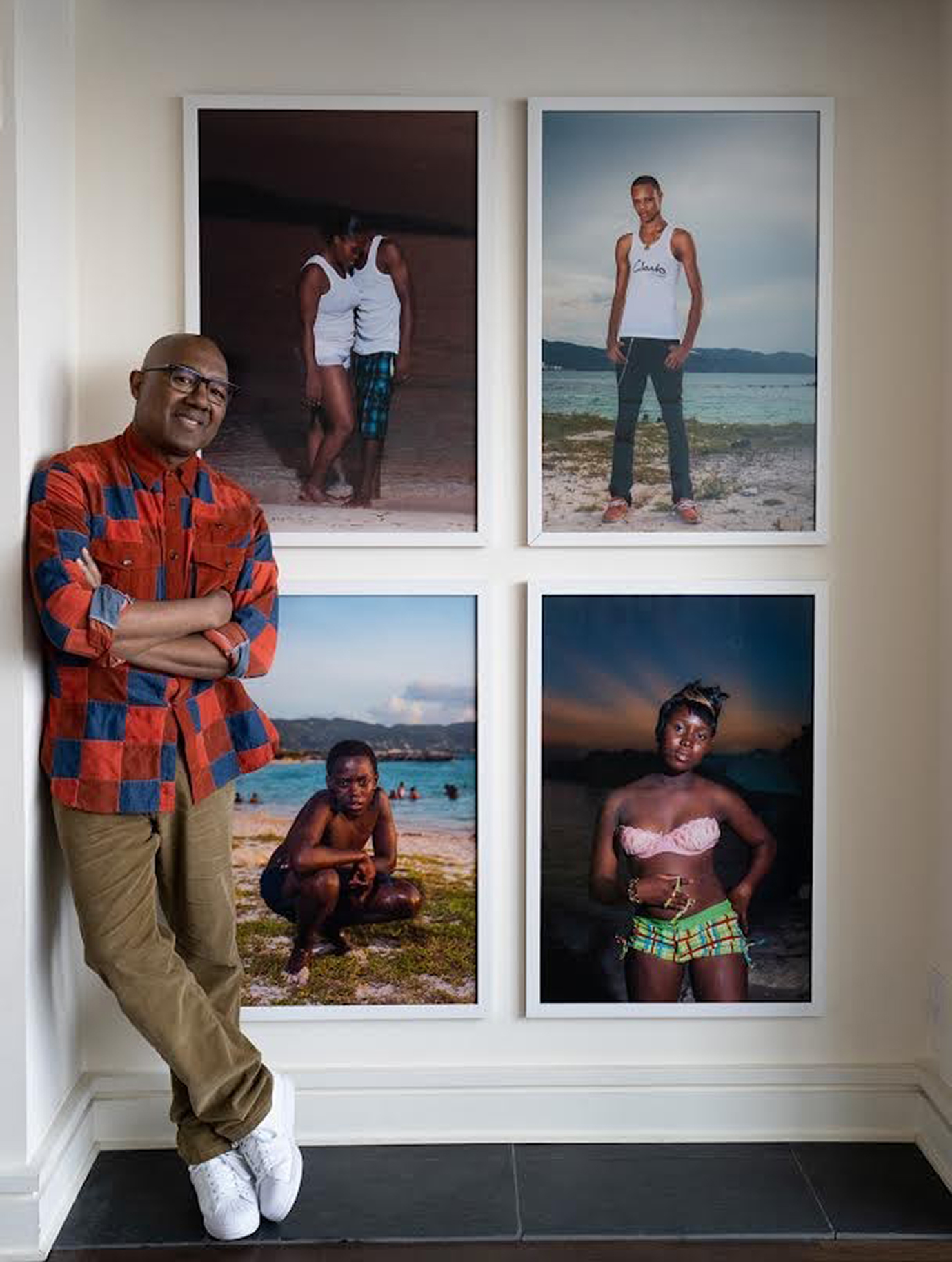 Photo of Dr. Kenneth Montague at home with paintings.