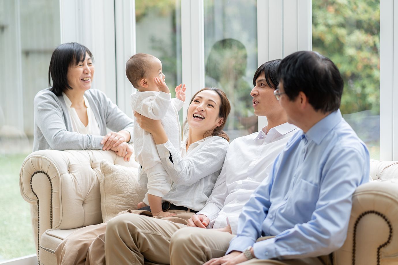Photo of multi-generational asian family on couch