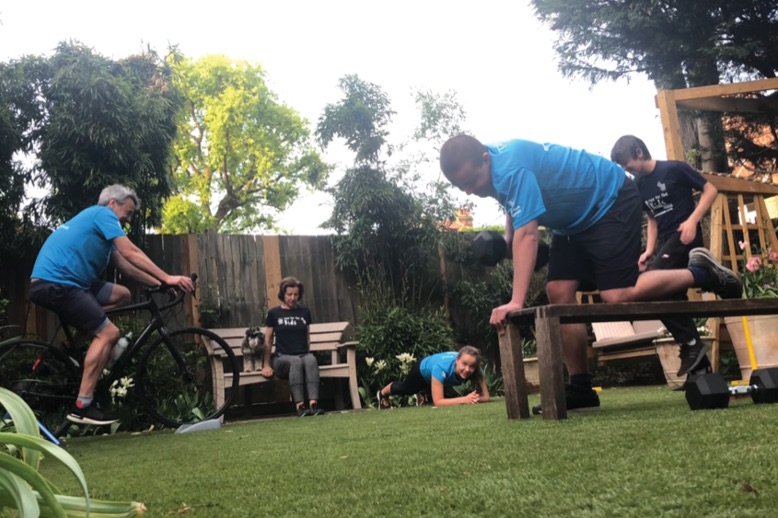 family doing fundraising workout in backyard gym