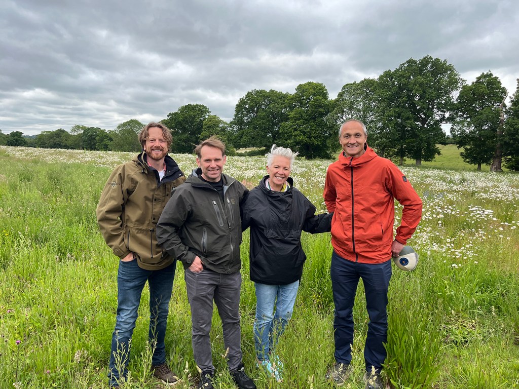Four adults are standing in a green field, with trees in the background. They are all wearing jeans and coats. Glenn Andersen, farmer and founder of Wendling Beck; Andrew Craig, head of ESG – RBC Europe; Desiree Clarke-Noble, global head, Sustainability & Impact, RBC Capital Markets; Tom Blathwayt, Sustainability Group director for RBC’s European businesses. 