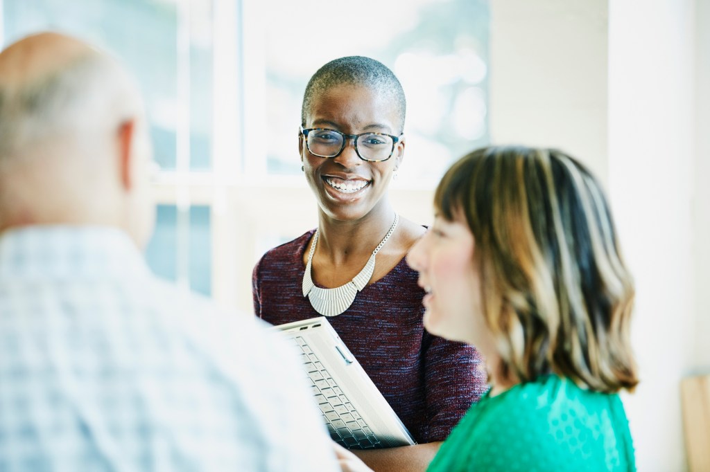 female colleagues having a discussion in an office setting