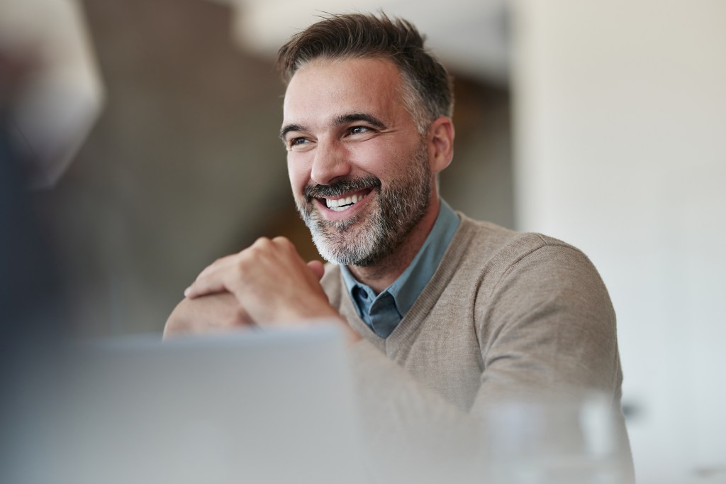 man smiling at desk