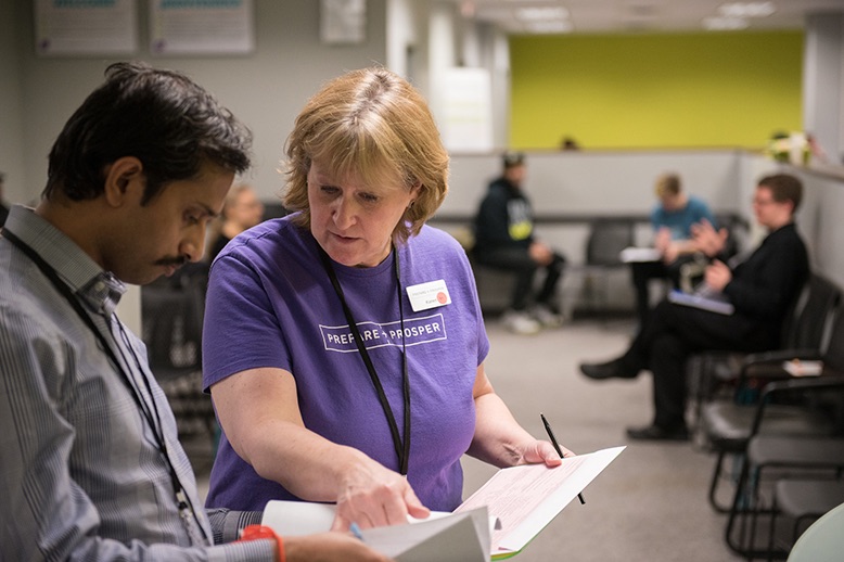 a prepare and prosper volunteer works with a customer