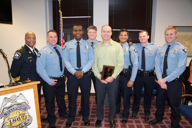 brad peper and minneapolis police officers at award ceremony