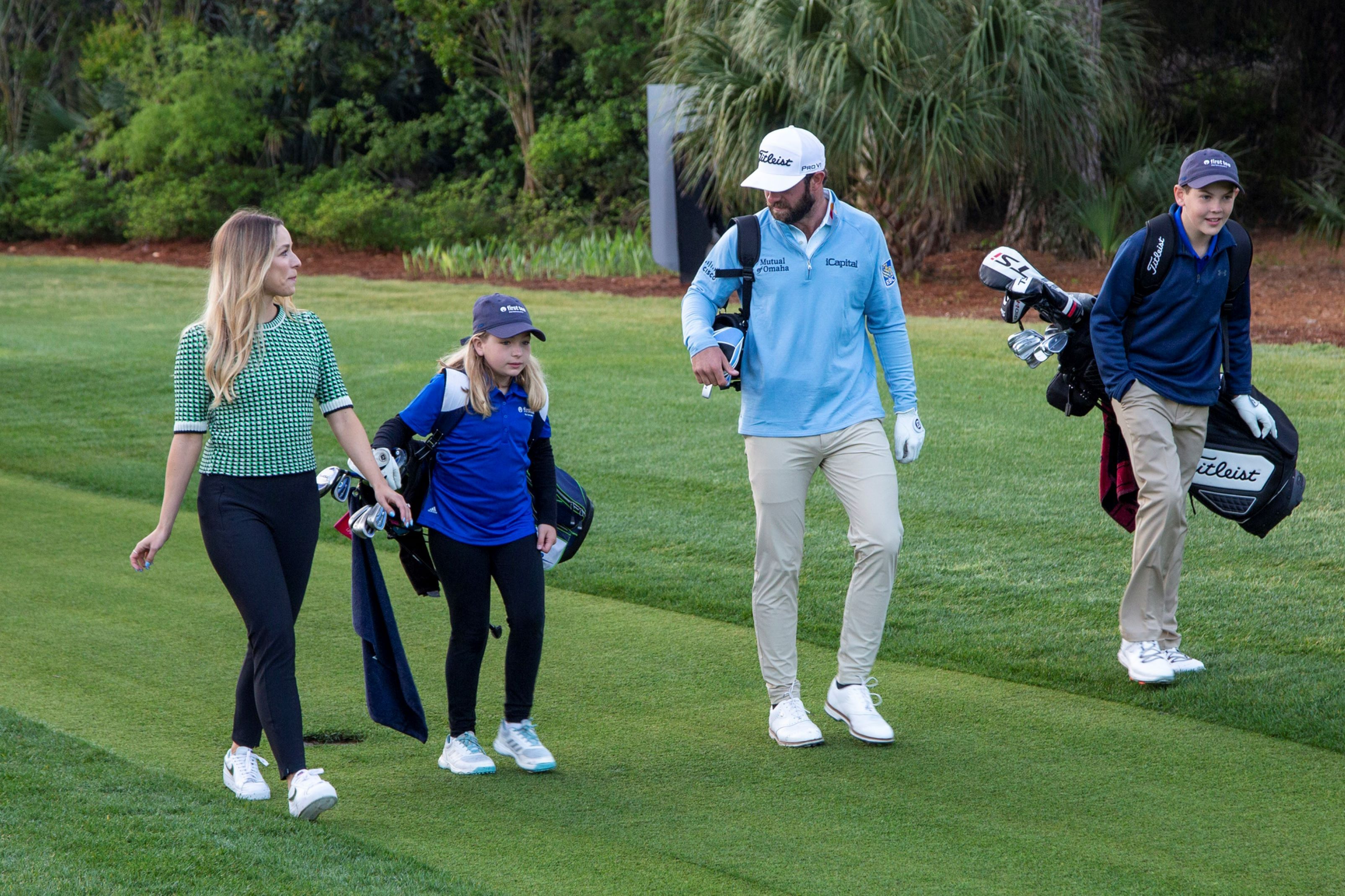 Photo of Team RBC golf ambassador, Cameron Young walking with 11-year-old Paul Morrell and 9-year-old Believe King at the 2023 RBC Heritage.