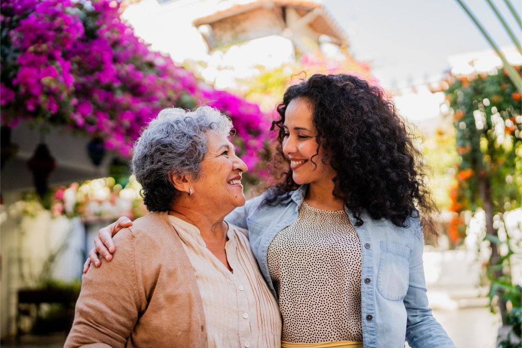 senior mother and daughter in garden centre
