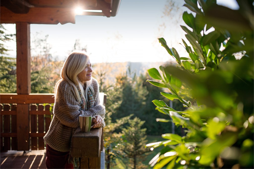 senior woman with tea on outdoor terrace