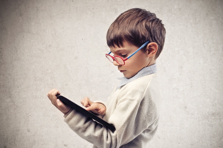 Boy with glasses using tablet