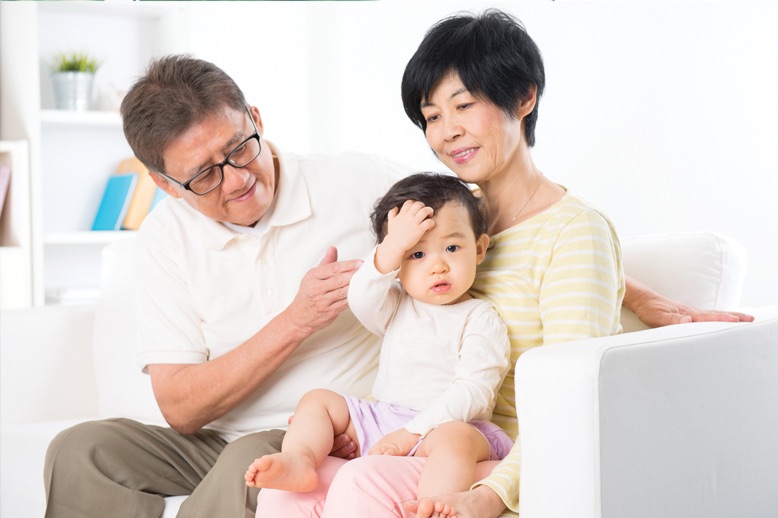 parents baby sitting on couch