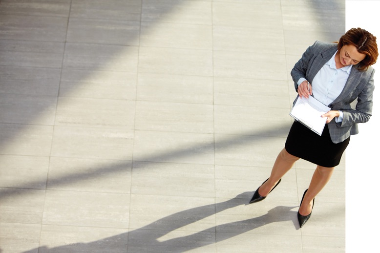 professional woman writing on clipboard