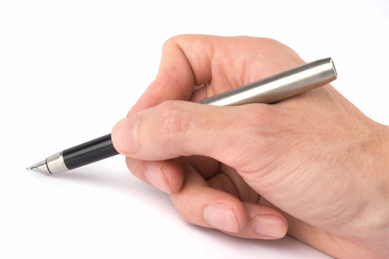 hand holding calligraphy pen